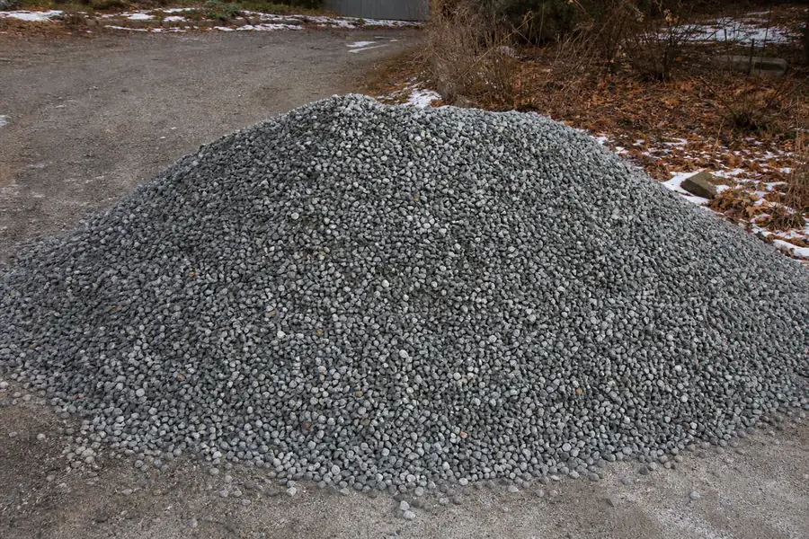 Pile of fresh crushed stone dumped on a driveway before winter