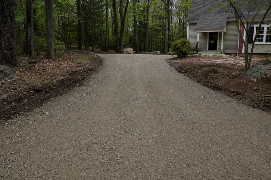 Freshly graded Connecticut driveway covered in compacted processed gravel base material